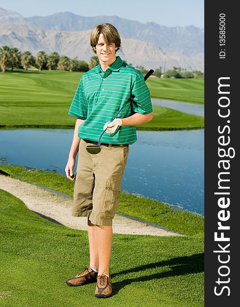 Golfer Standing On Golf Course Green