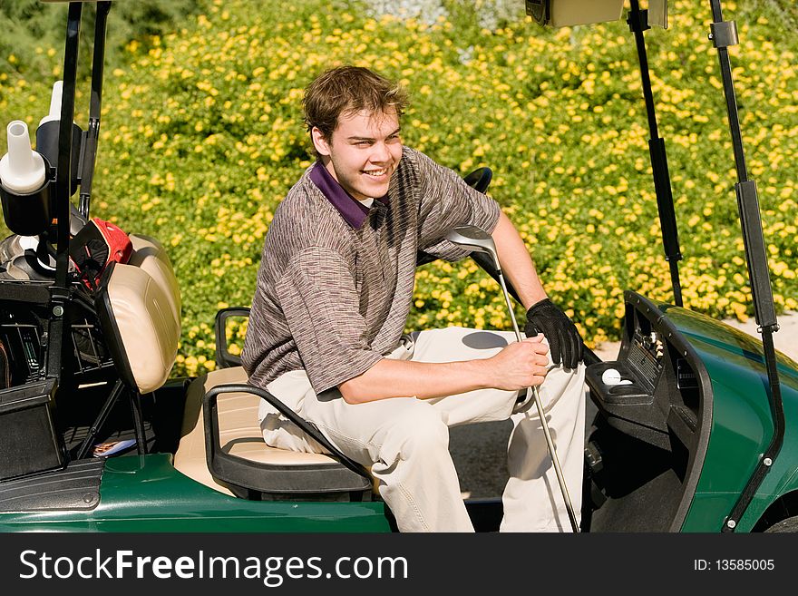 Golfer sitting in golf cart