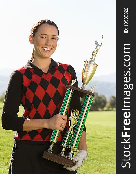 Female Golfer Holding Trophy