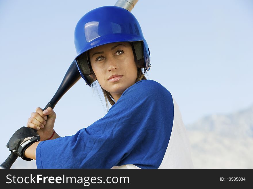 Young woman with softball bat, portrait