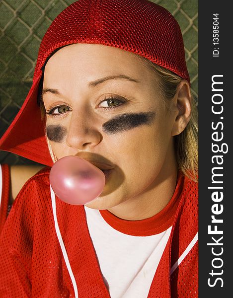 Softball player blowing bubblegum, portrait