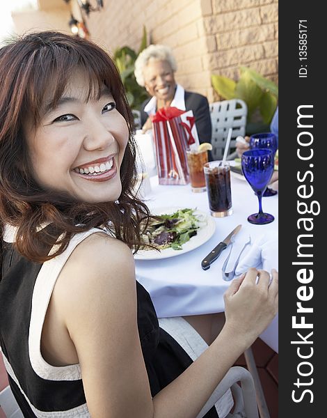 Smiling Woman Having Lunch With Friends