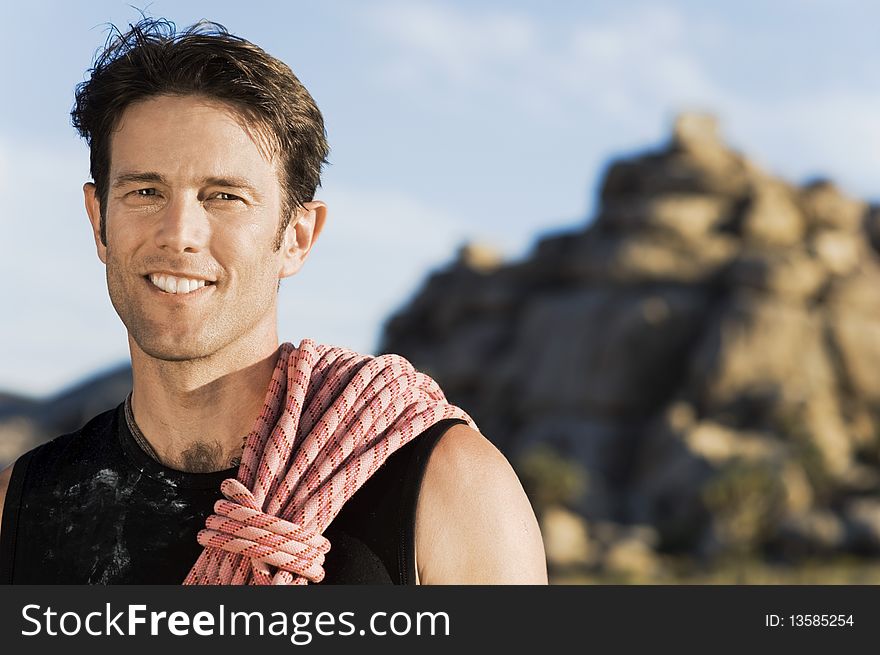 Male Rock climber with Rope on Shoulder,. Male Rock climber with Rope on Shoulder,