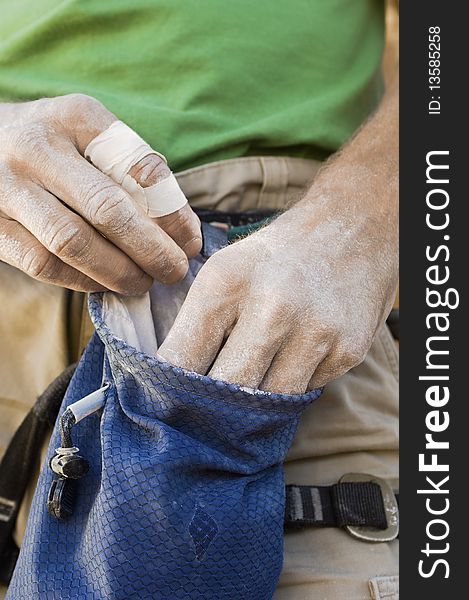 Climber Getting Chalk from Chalk Bag, mid section, close-up, (close-up)