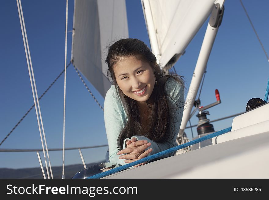 Young woman on sailboat, (portrait)