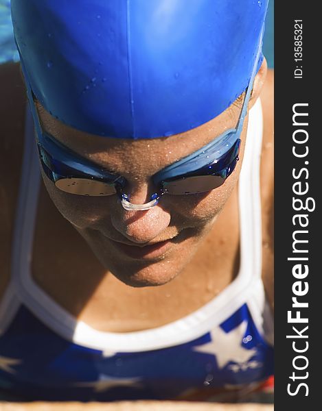 Female swimmer in cap and goggles, (close-up)