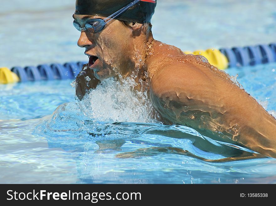 Competitive male Swimmer in outdoor pool. Competitive male Swimmer in outdoor pool