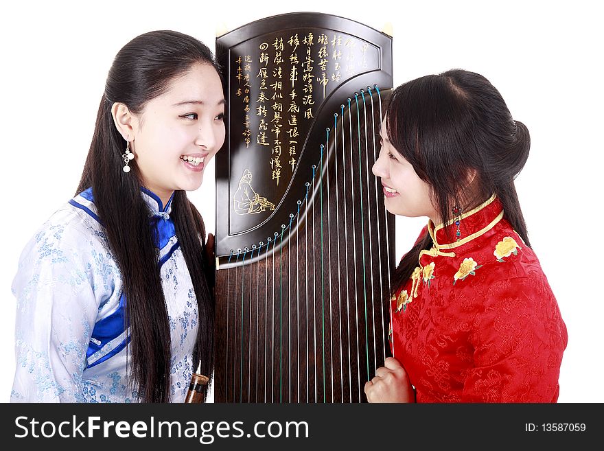 Two Chinese musicians with bamboo flute and zither talking on white. Chinese characters on the flute means wonderful voice,it is taken from one of China's ancient poetry. Chinese character on zither is Chinese Tang poetry,also a famous Tang Dynasty poet's calligraphy. It praised the unique charm of the zither.