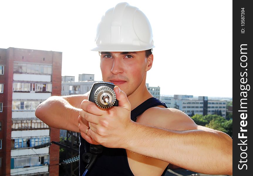 Muscular young man in a builder uniform.