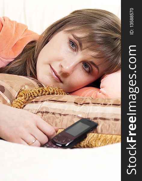 Portrait of a young woman lying in her bed crying. You can see the tears in her eyes. Portrait of a young woman lying in her bed crying. You can see the tears in her eyes