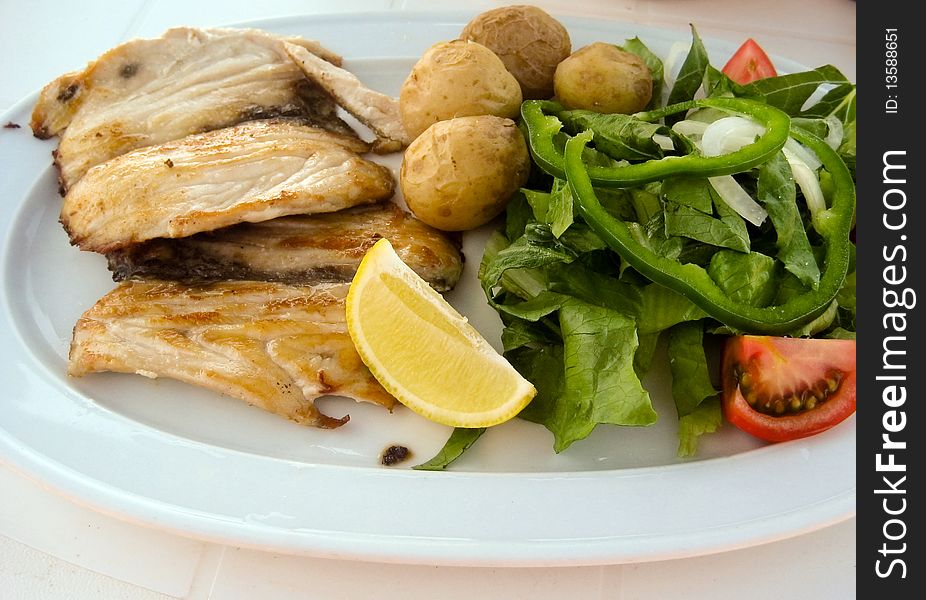 Roast cutlet of pork with boiled potatoes and salad