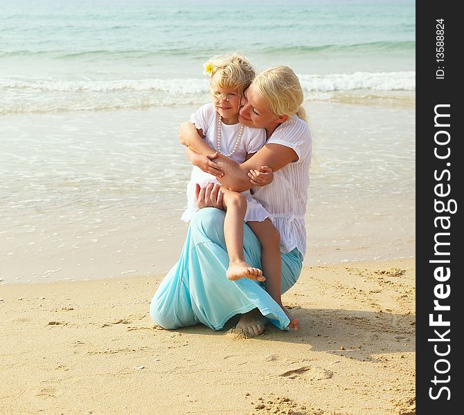 Little girl with her mother on the beach. Little girl with her mother on the beach