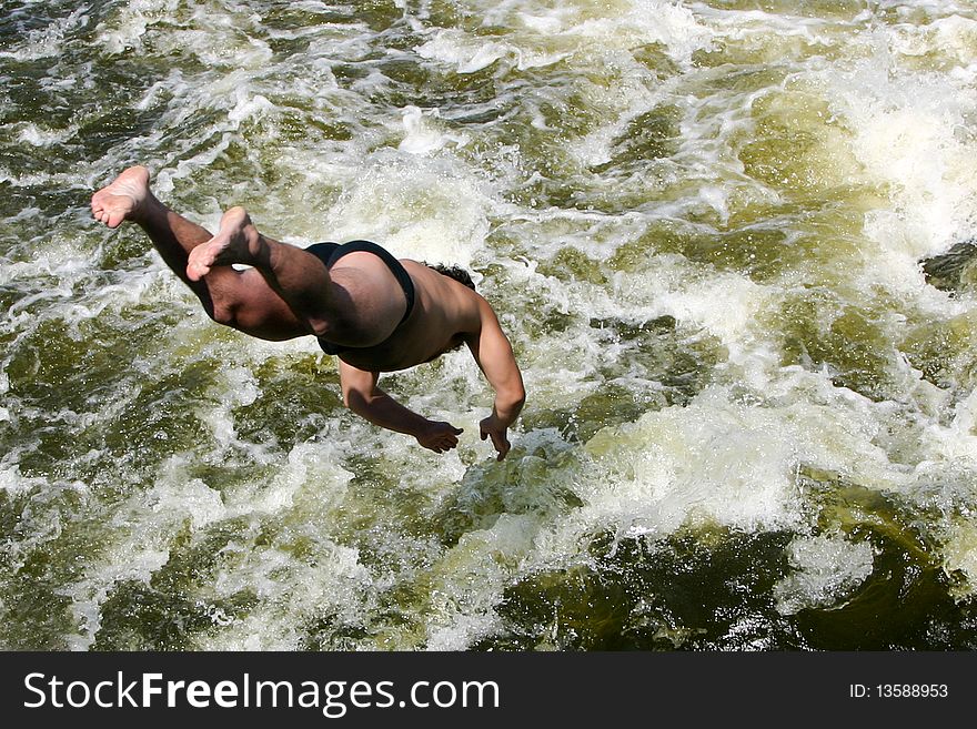 An image of a man jumping into a river