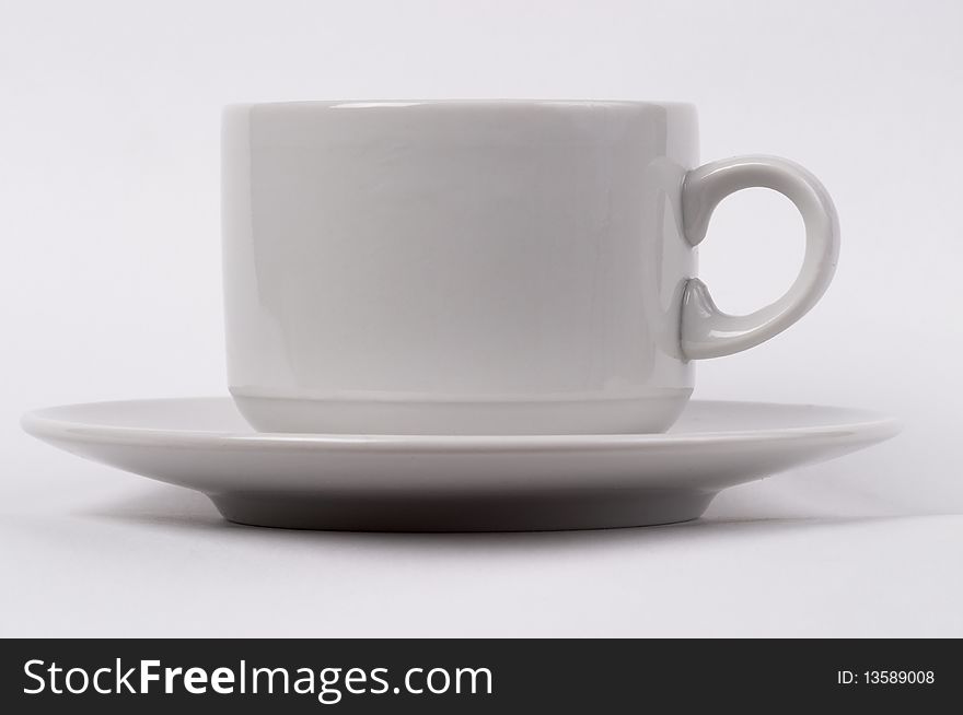 Little white tea cup isolated over grey gradient background