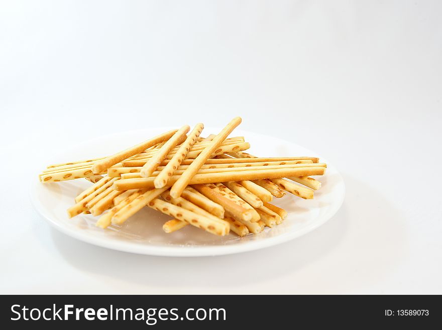 A famous asian snack called cracker sticks served in a plate.