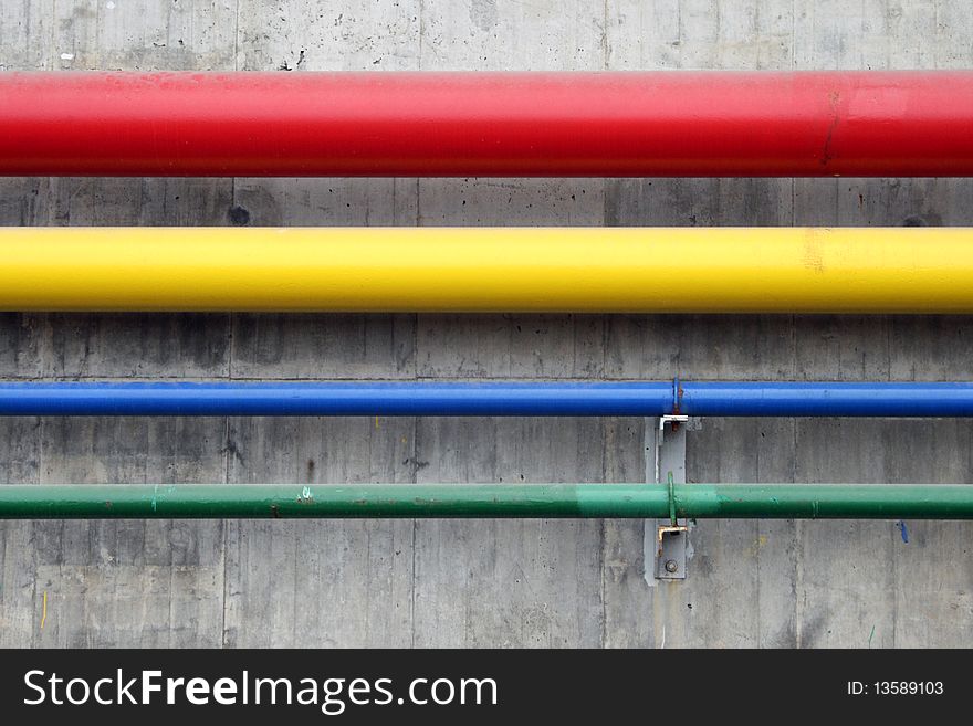 Steel pipes in a shipyard are painted in bright colours to distinguish their purpose. Steel pipes in a shipyard are painted in bright colours to distinguish their purpose.