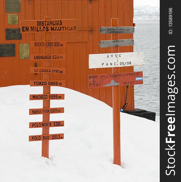 A sign post in the Antarctic depicting the distances to various locations around the world. A sign post in the Antarctic depicting the distances to various locations around the world.