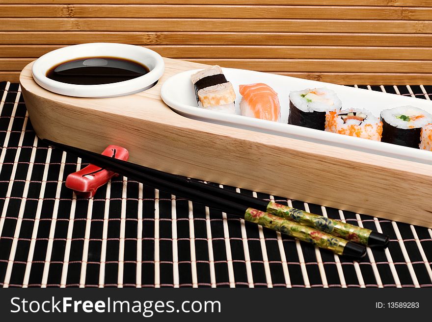 An image of a set of tasty sushi and chopsticks