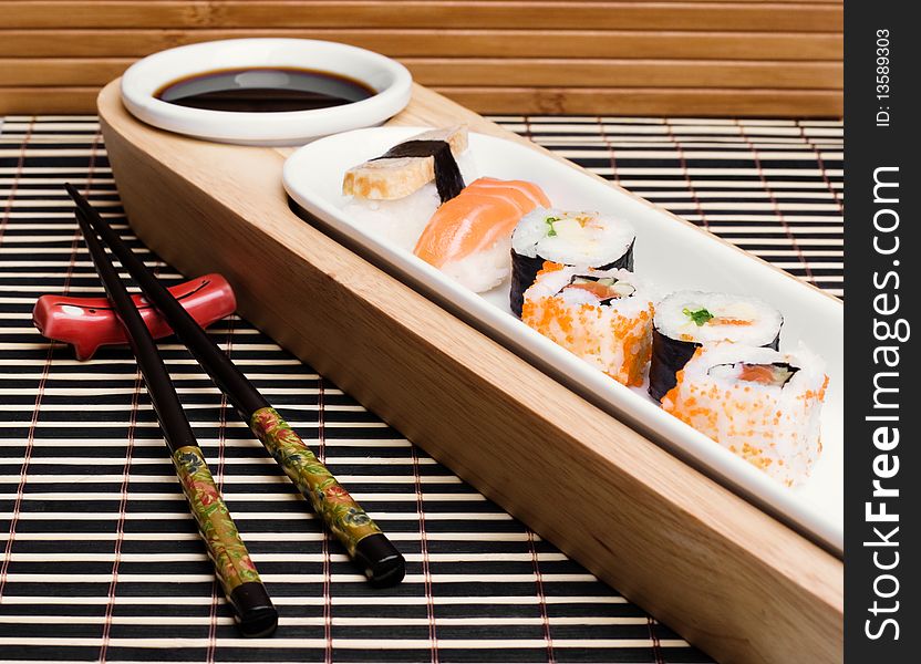 An image of a set of tasty sushi and chopsticks