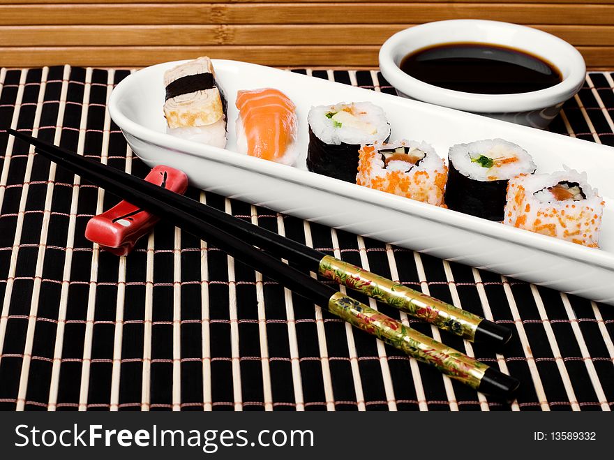 An image of a set of sushi and chopsticks