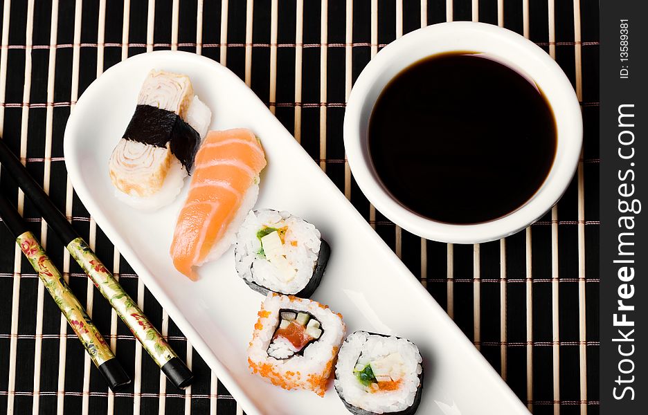 An image of a set of sushi and soy