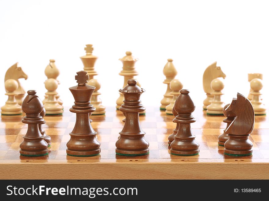 Chessmen on the board on white background. Chessmen on the board on white background