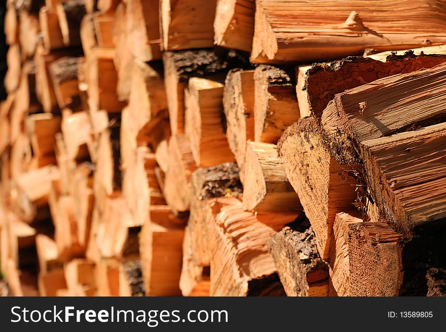 Split firewood stacked up in a big neat pile.