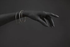 Black Woman`s Hand With Silver Jewelry. Oriental Bracelets On A Black Painted Hand. Silver Jewelry Stock Photography
