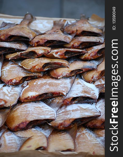 Smoked fish selling by fisherman near the sea