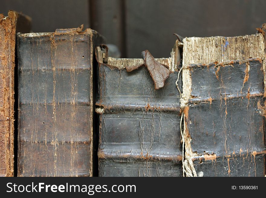 Three old books with tattered bindings