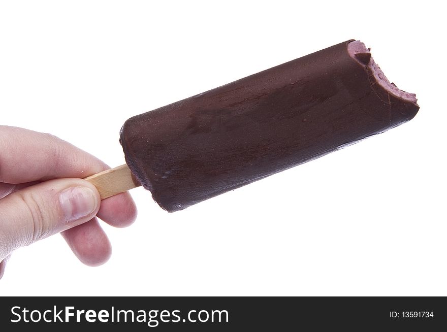 Ice Cream on a Stick in a Caucasian Hand Isolated on White.