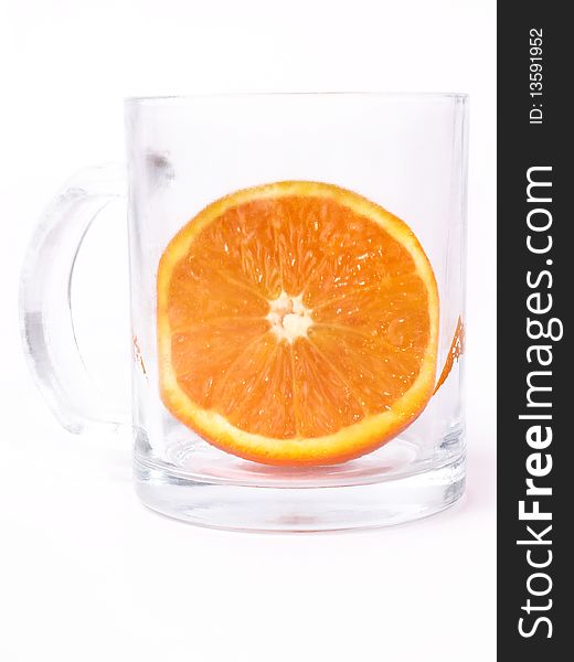 Juicy orange in glass on white background