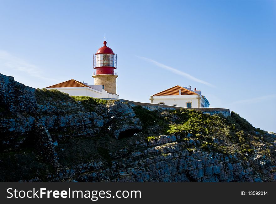 Lighthouse of Cabo de SÃ£o Vicente, on top of a rock against the blue sky. Lighthouse of Cabo de SÃ£o Vicente, on top of a rock against the blue sky.