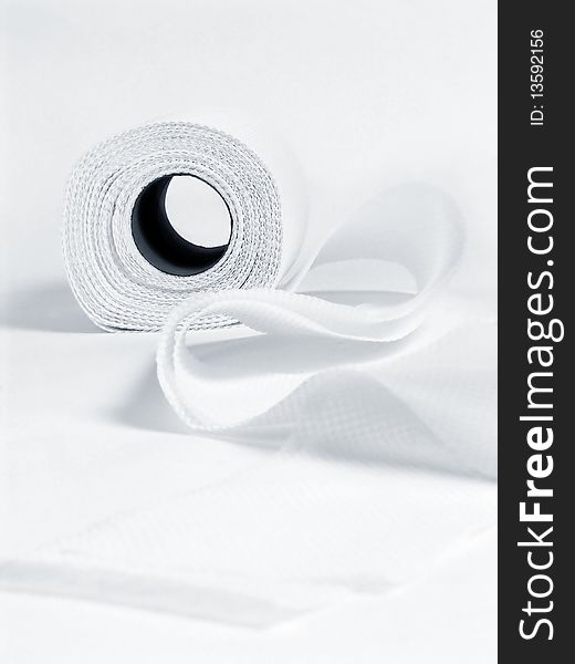 Roll of white toilet paper, on white background with shadow
