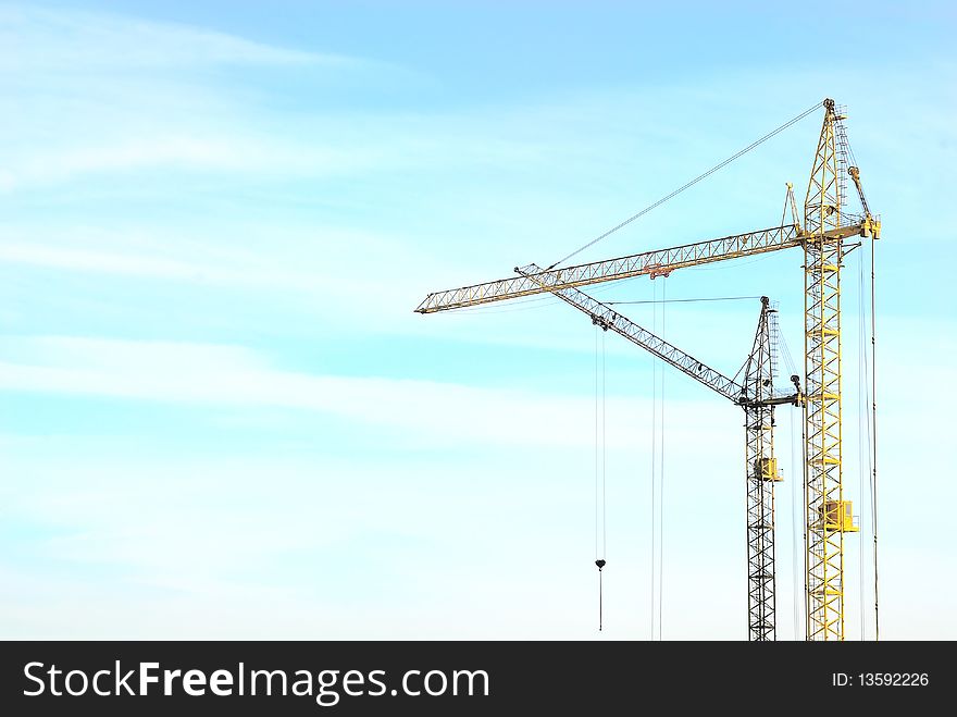 Two stationaty cranes over blue sky. Two stationaty cranes over blue sky