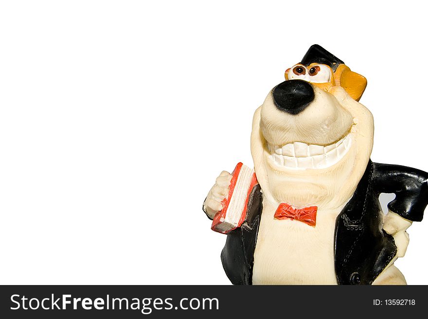 Toy dog-pupil with the book in hands, a hat and a