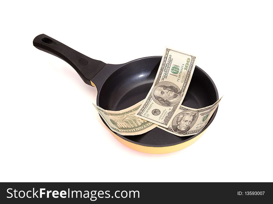 Frying pan with dollar bills isolated