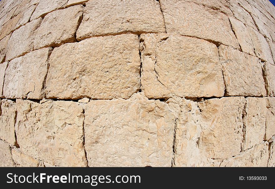 Convex ancient stone wall texture of beige sandstone blocks