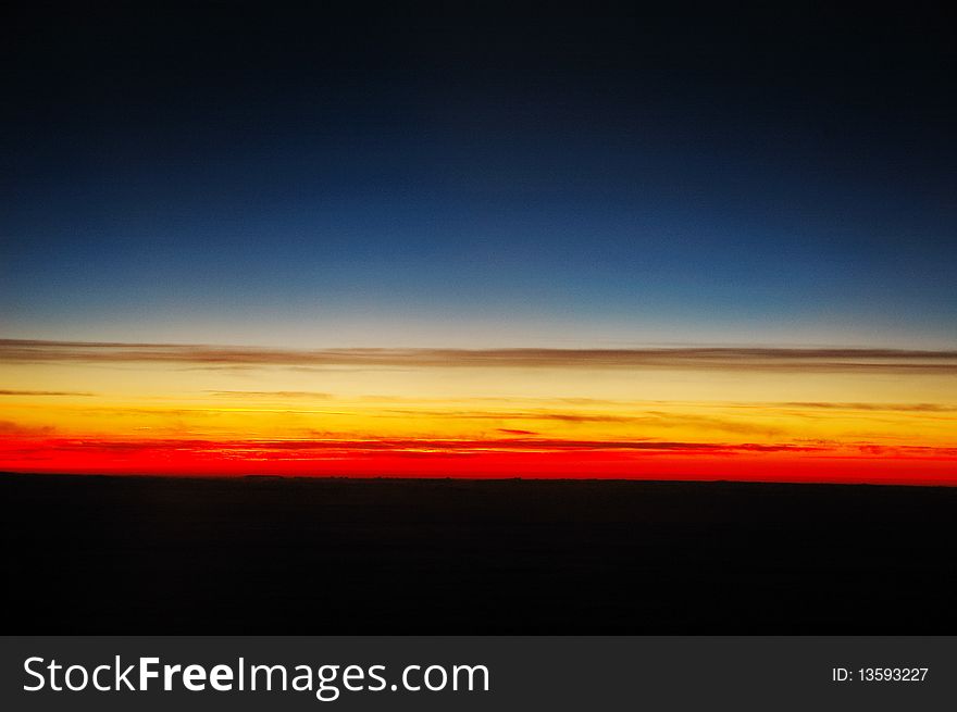 Beautiful and corourful sunset above clouds, shot taken from plane