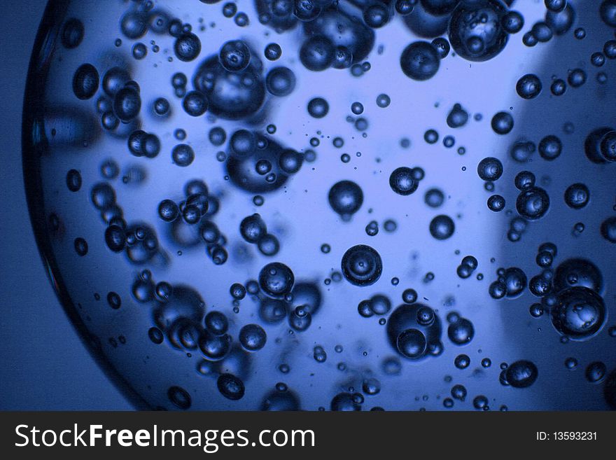 Bubbles in a glass ball tinted blue. Bubbles in a glass ball tinted blue