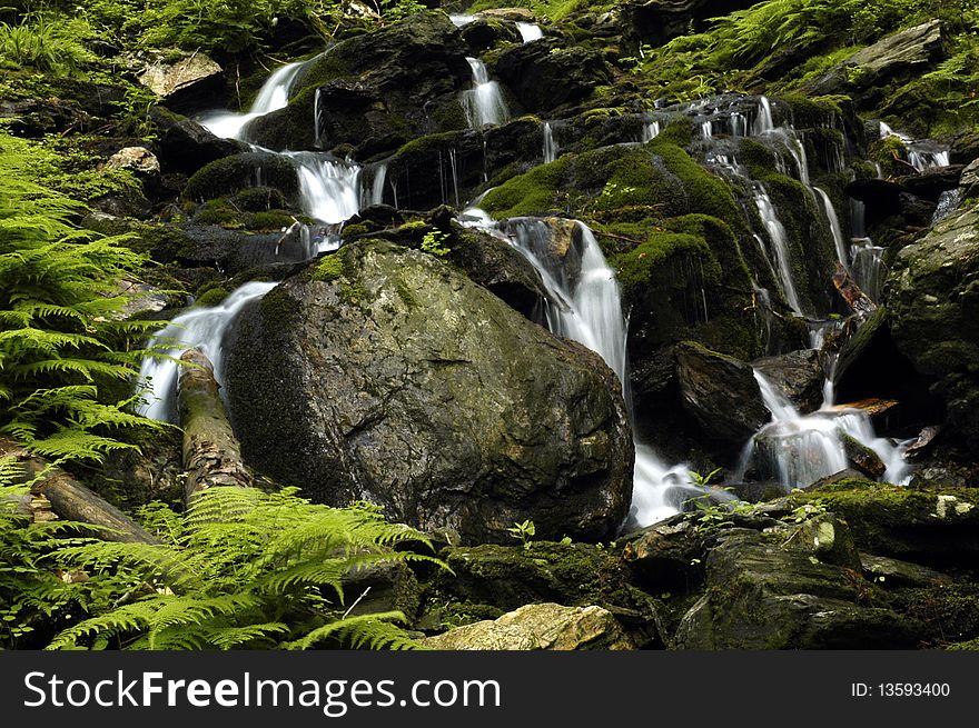 Small waterfall in czech mountain, vertically framed shot. Small waterfall in czech mountain, vertically framed shot