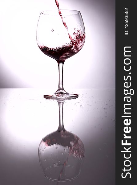 Splashing wine in to the wineglass. Splashing wine in to the wineglass