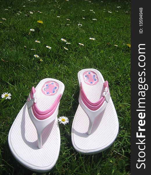 Summer sandals on green grass