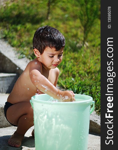 Very cute child playing with water outdoor