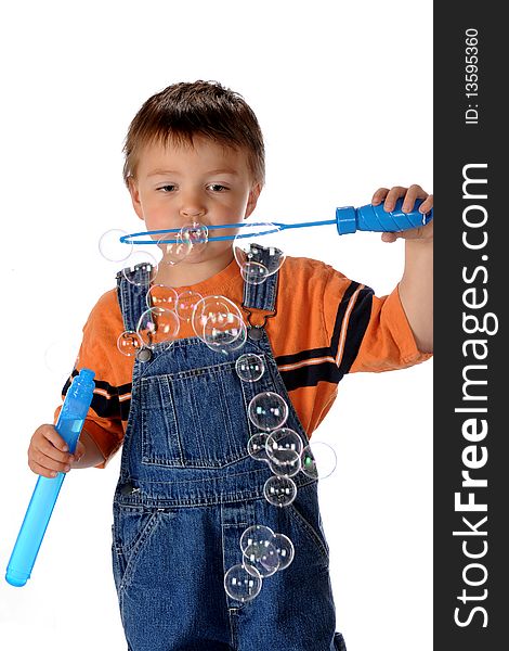 A preschool boy blowing bubbles with a giant bubble-wand.  Isolated on white. A preschool boy blowing bubbles with a giant bubble-wand.  Isolated on white.