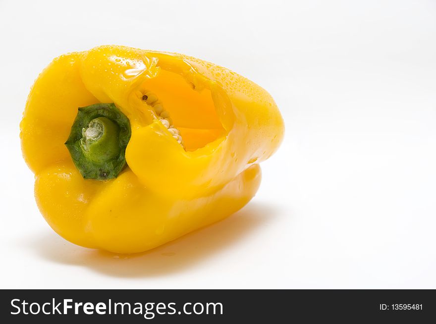 The yellow pepper on the white background