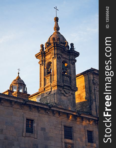 Chapel of the ancient church on the background of the morning sky in the sun rising in Santiago de Compostela Cathedral