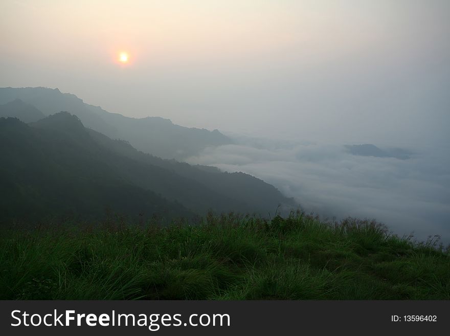 Sunrise Beyond Mountain With Fog