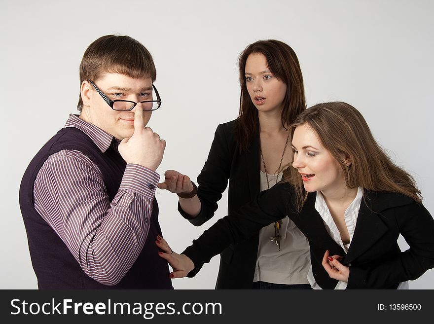 Two girls show interest in man on white background