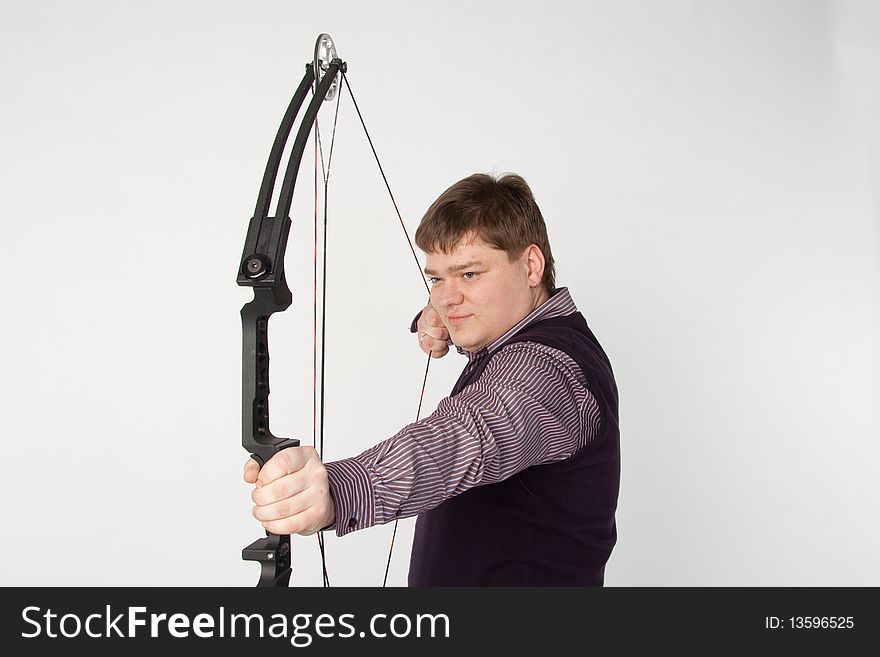 Man shoots compound bow. Isolated on white background